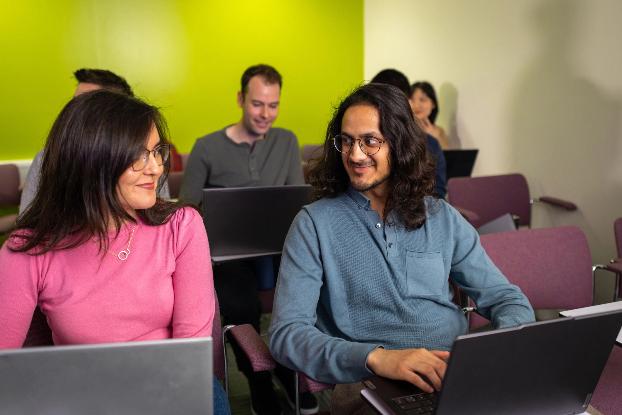 Professionals attending a collaborative technology session