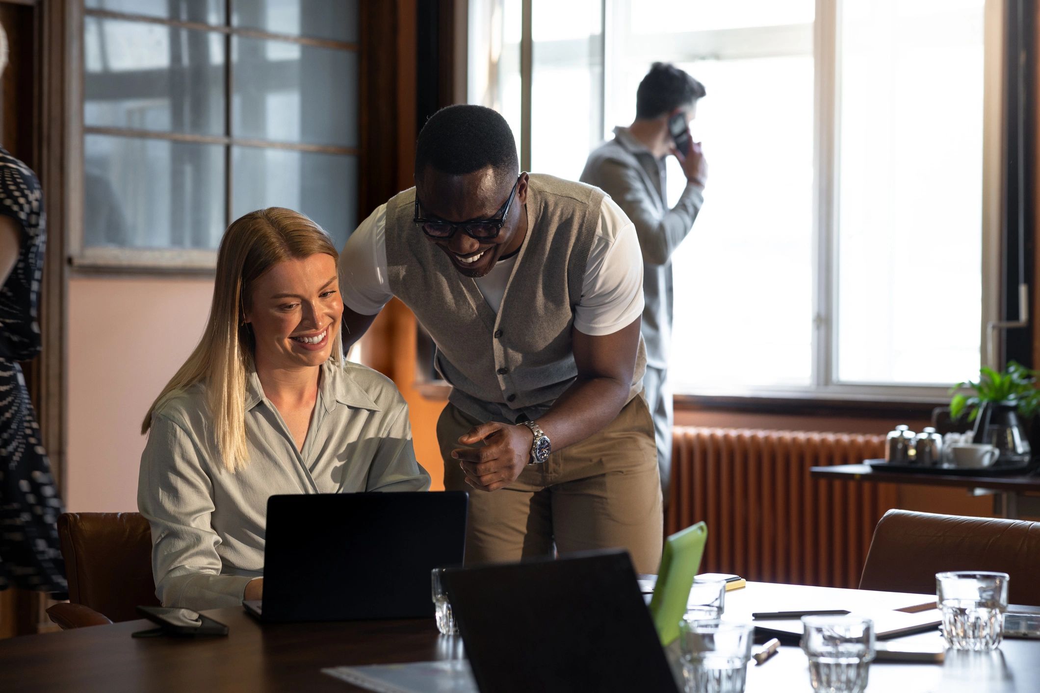 Professionals reviewing information together on a laptop